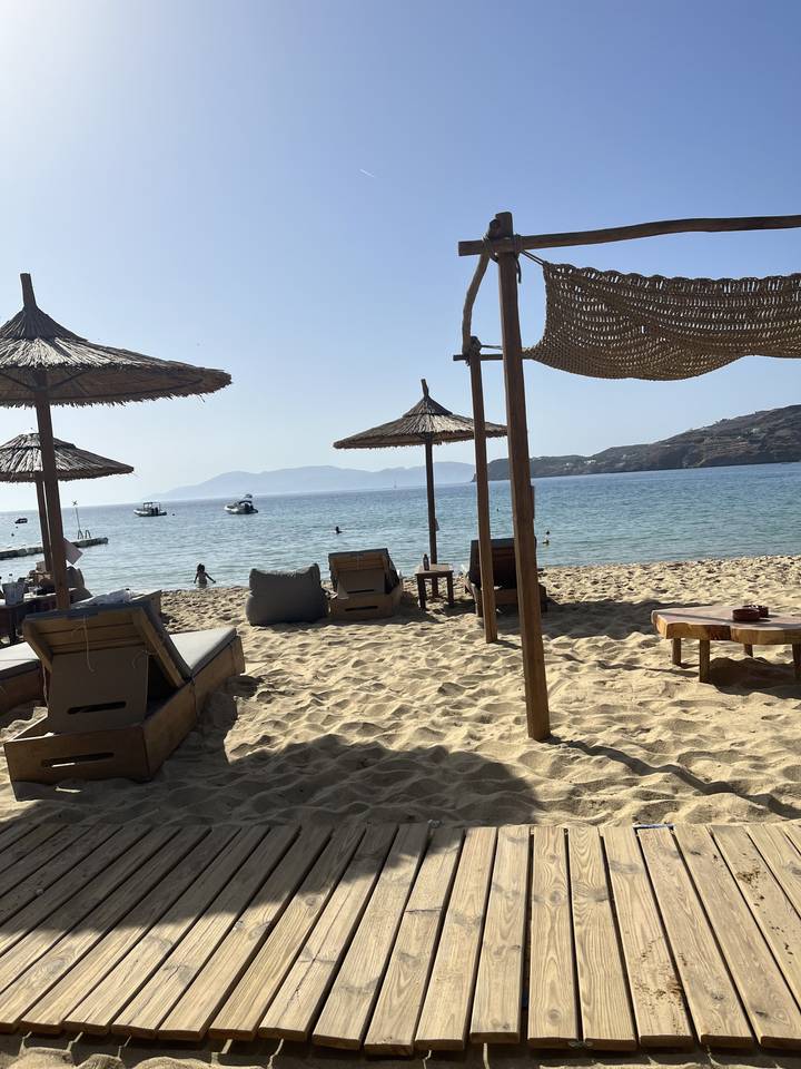 Empty beach section with umbrellas and lounge chairs.