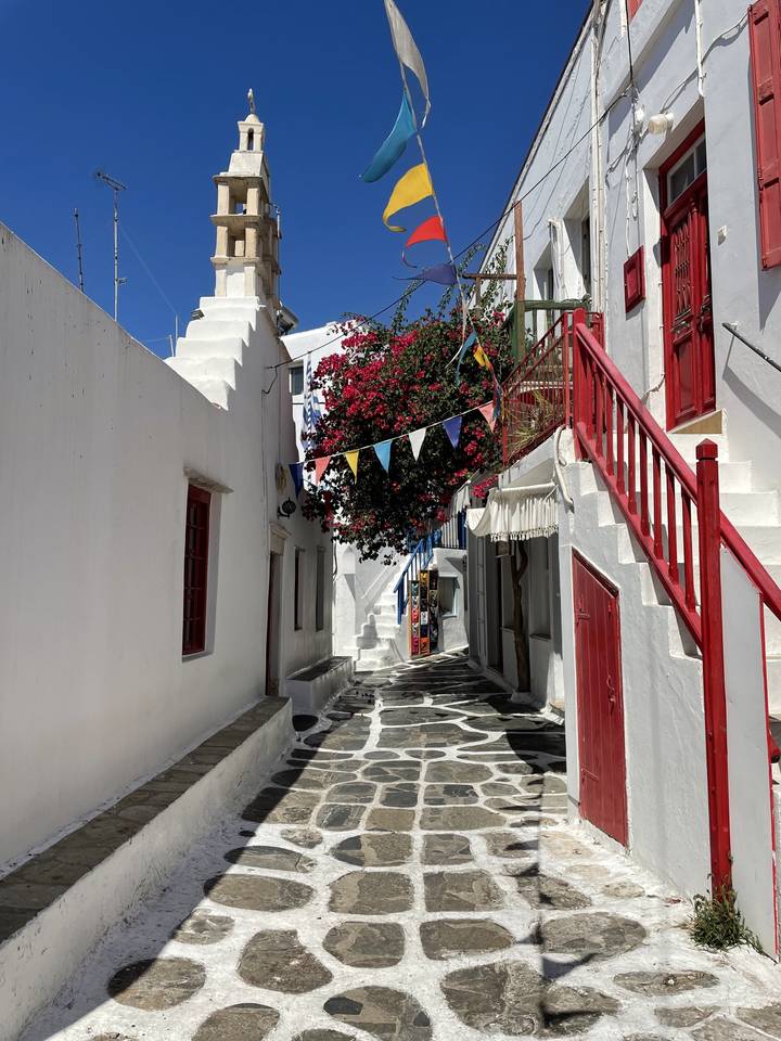 Traditional Greek street with churches and flags