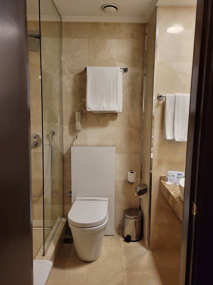 Bathroom with marble tiles and shower area.