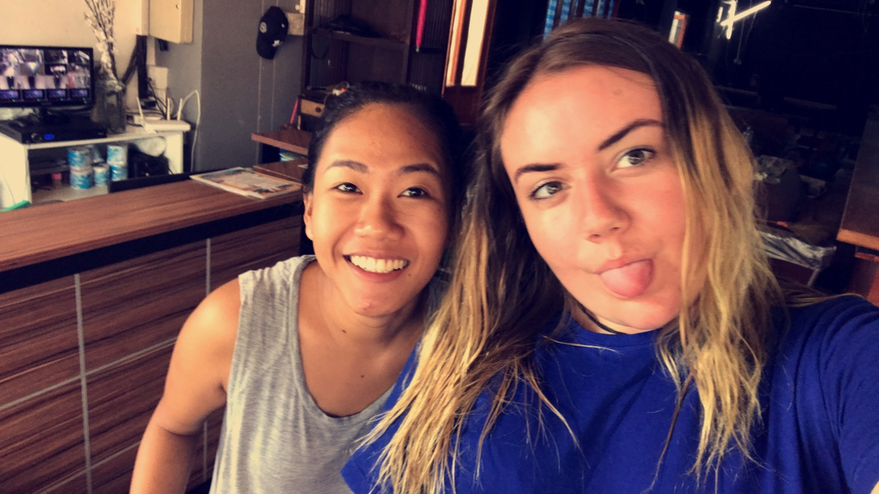 Two women posing and making funny faces in an indoor area.