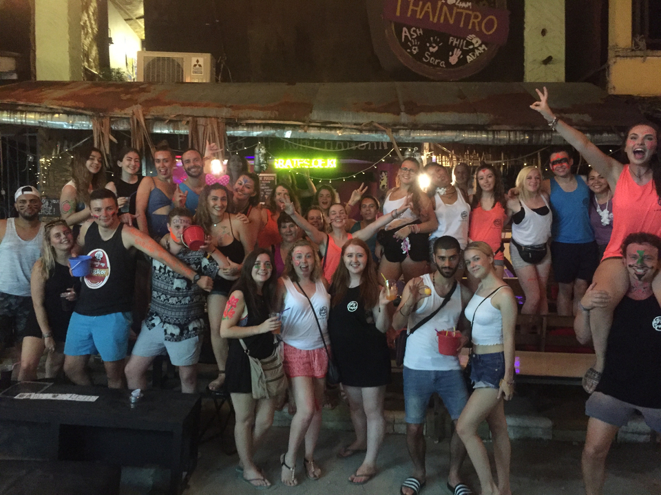 Large group of people in a nightlife setting.