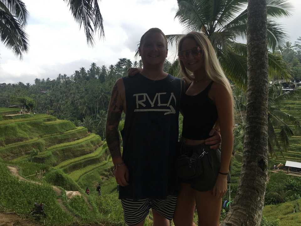 Couple posing in front of rice terraces.