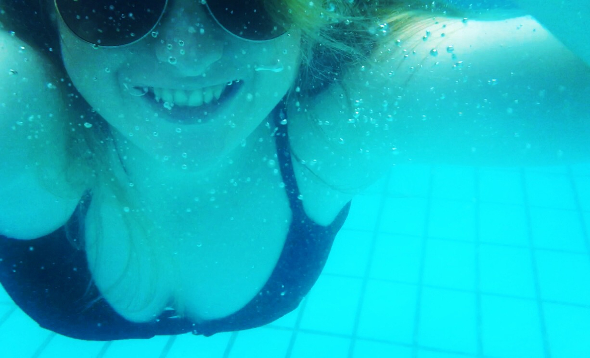 An underwater selfie of a person in a pool.
