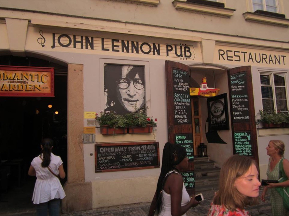 Front of a restaurant named after John Lennon with people nearby.