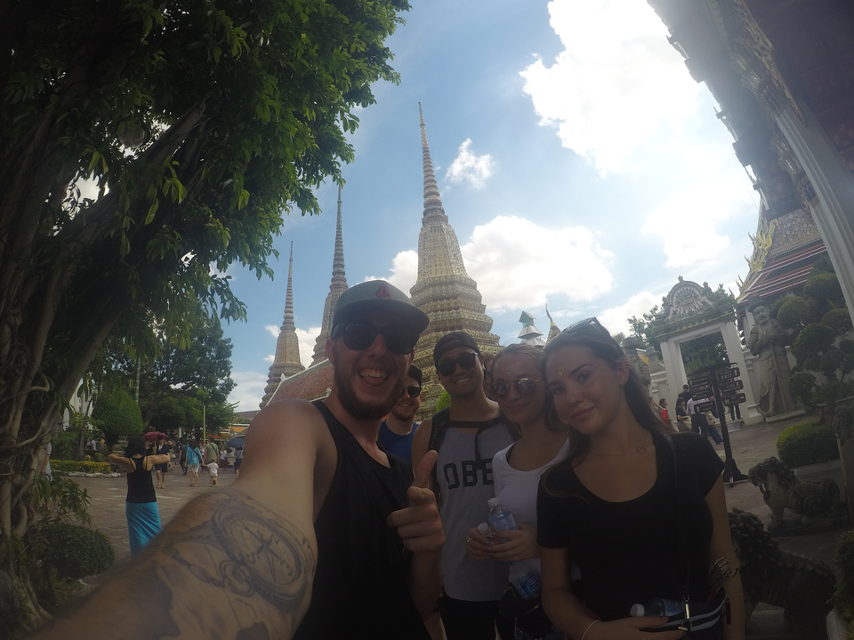 A group selfie with temple spires in the background.
