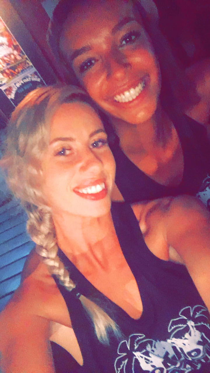 Close-up of a smiling person with an indistinct background.