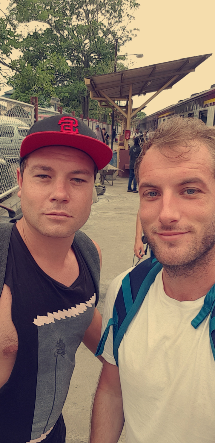 Two people taking a selfie in an urban setting.