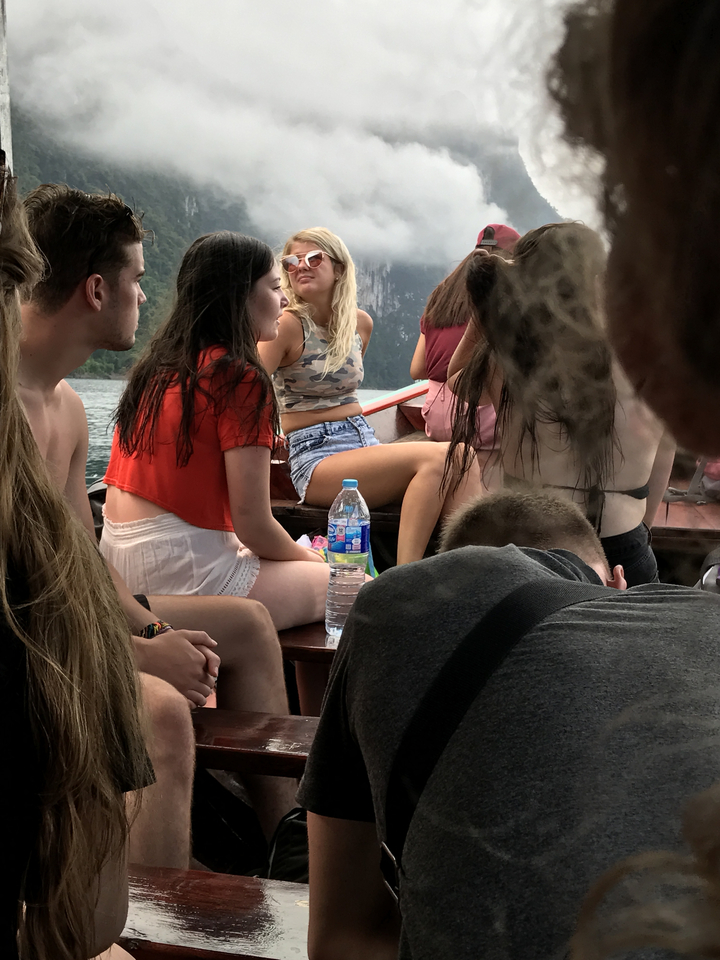 People sitting on a boat enjoying the view.