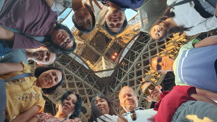 Group of people looking up at a famous structure.