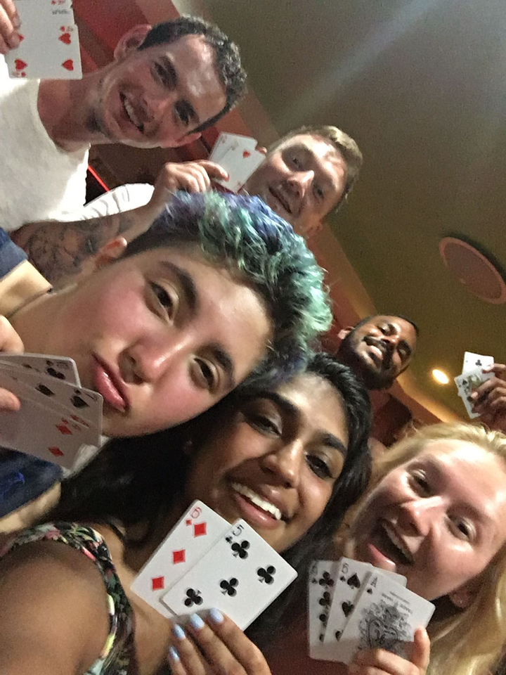 Close-up of a group of people playing cards