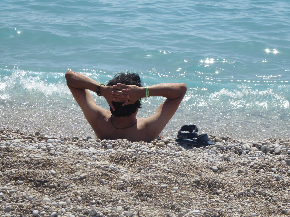 Personne se relaxant sur une plage de galets