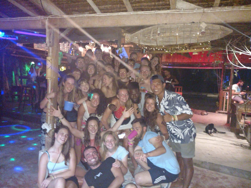 Large group of people partying in a club at night.