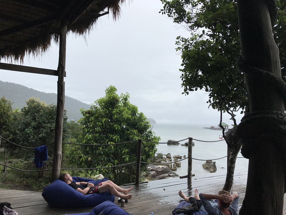 Peaceful waterfront view from a wooden deck.