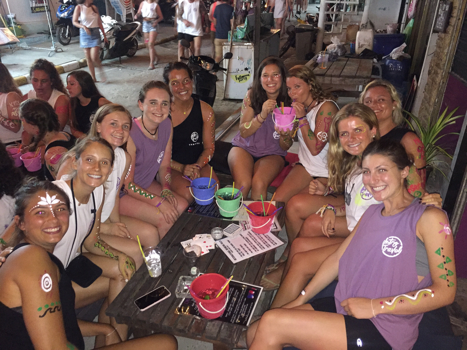 Group enjoying drinks at a bar with themed decorations.