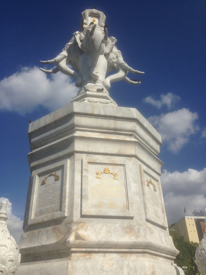 White marble monument against a blue sky.