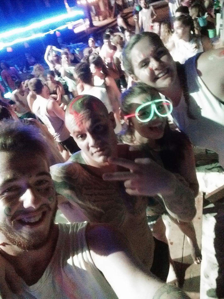 People at a party with neon lights and face paint.