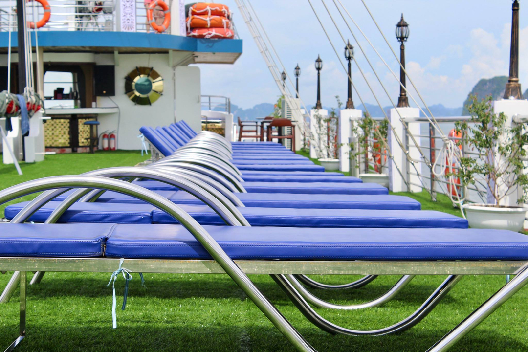 Row of sun loungers on a deck of a boat.