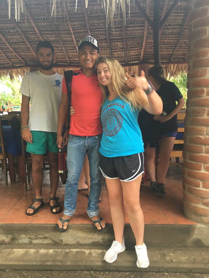 People inside a rustic restaurant area.