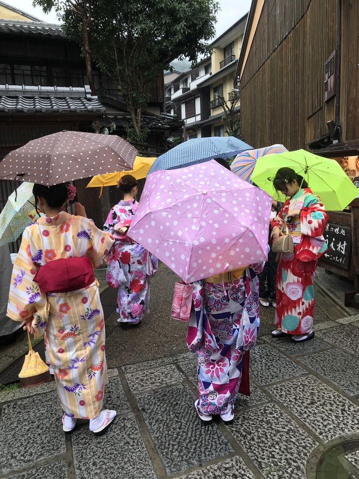 Groupe de personnes en yukata coloré tenant des parapluies.