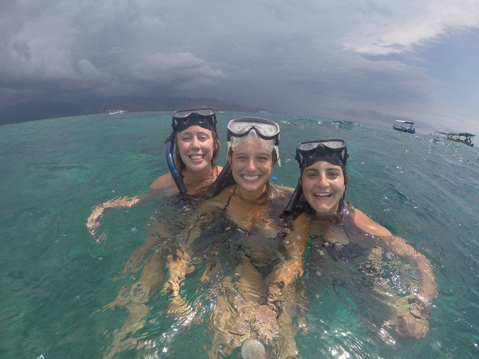 Group of friends snorkeling in clear waters.