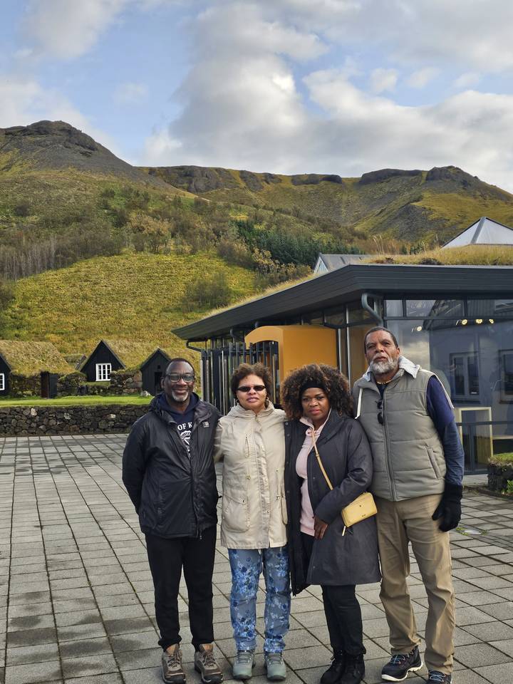 Group of people standing in front of a modern building.