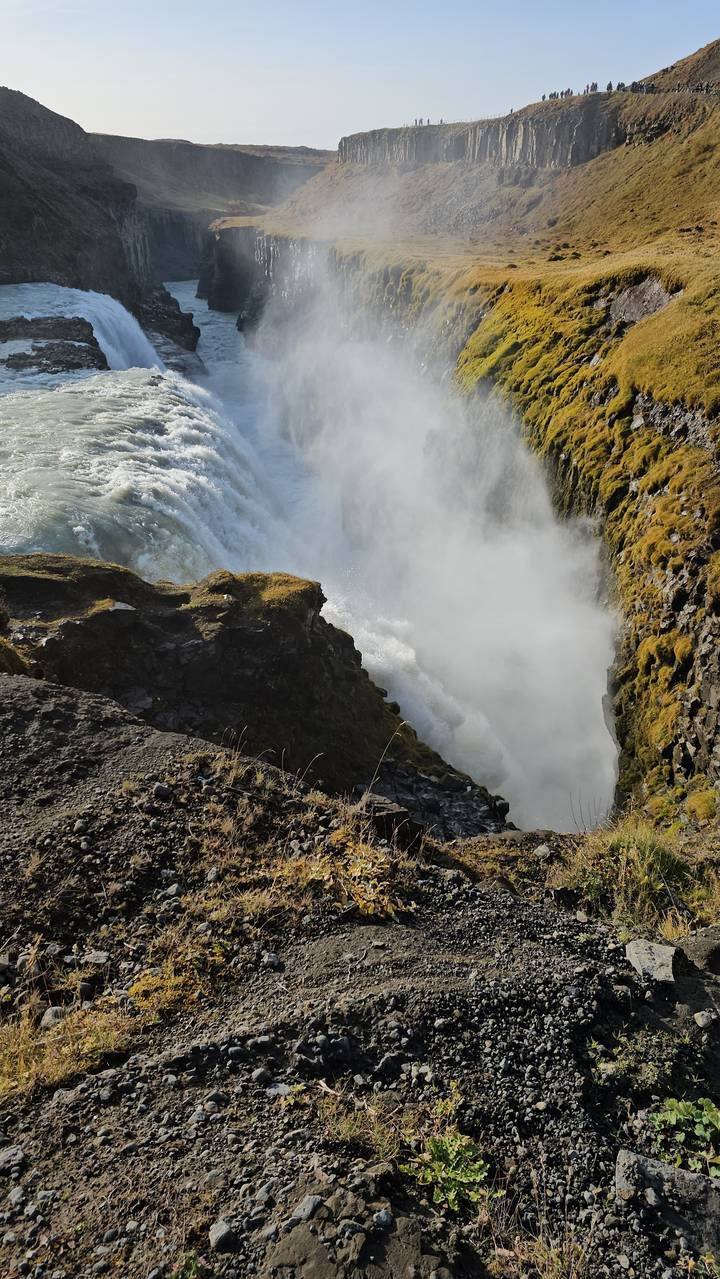 Large waterfall with mist rising from the base.
