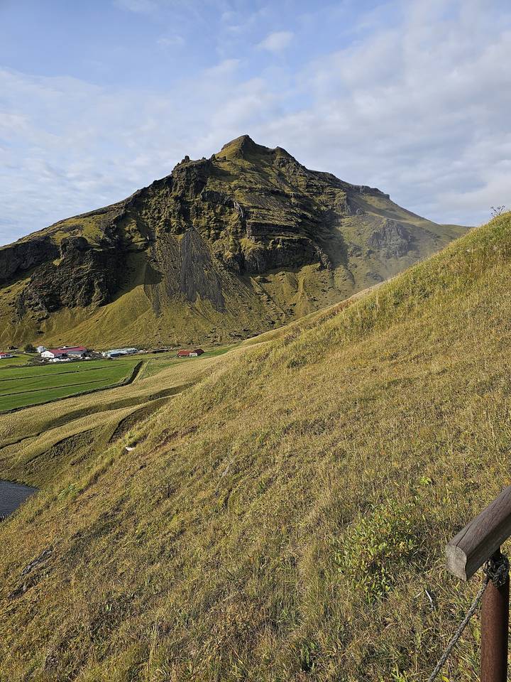 Grassy hillside landscape with a winding path.