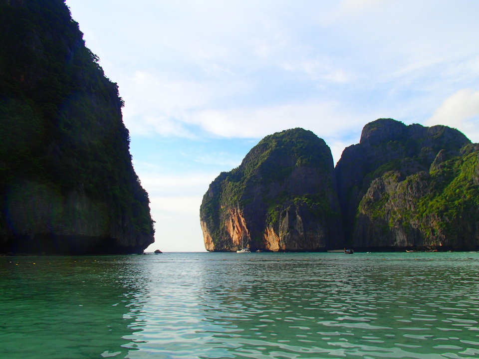 Dramatic cliffs meeting the ocean under a clear sky.