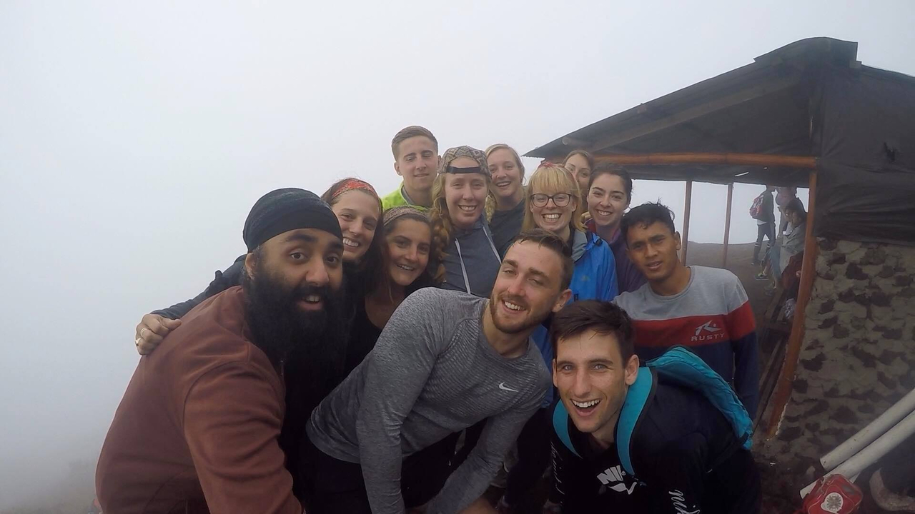 Group of people taking a selfie in foggy conditions.