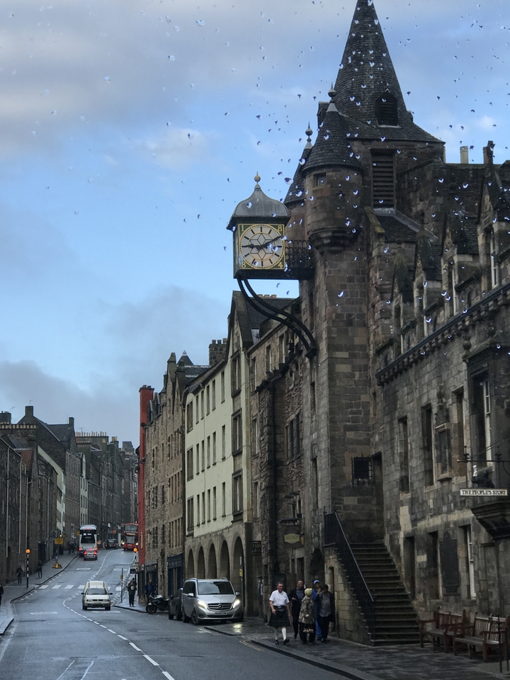 Historic clock on a building in a city street.