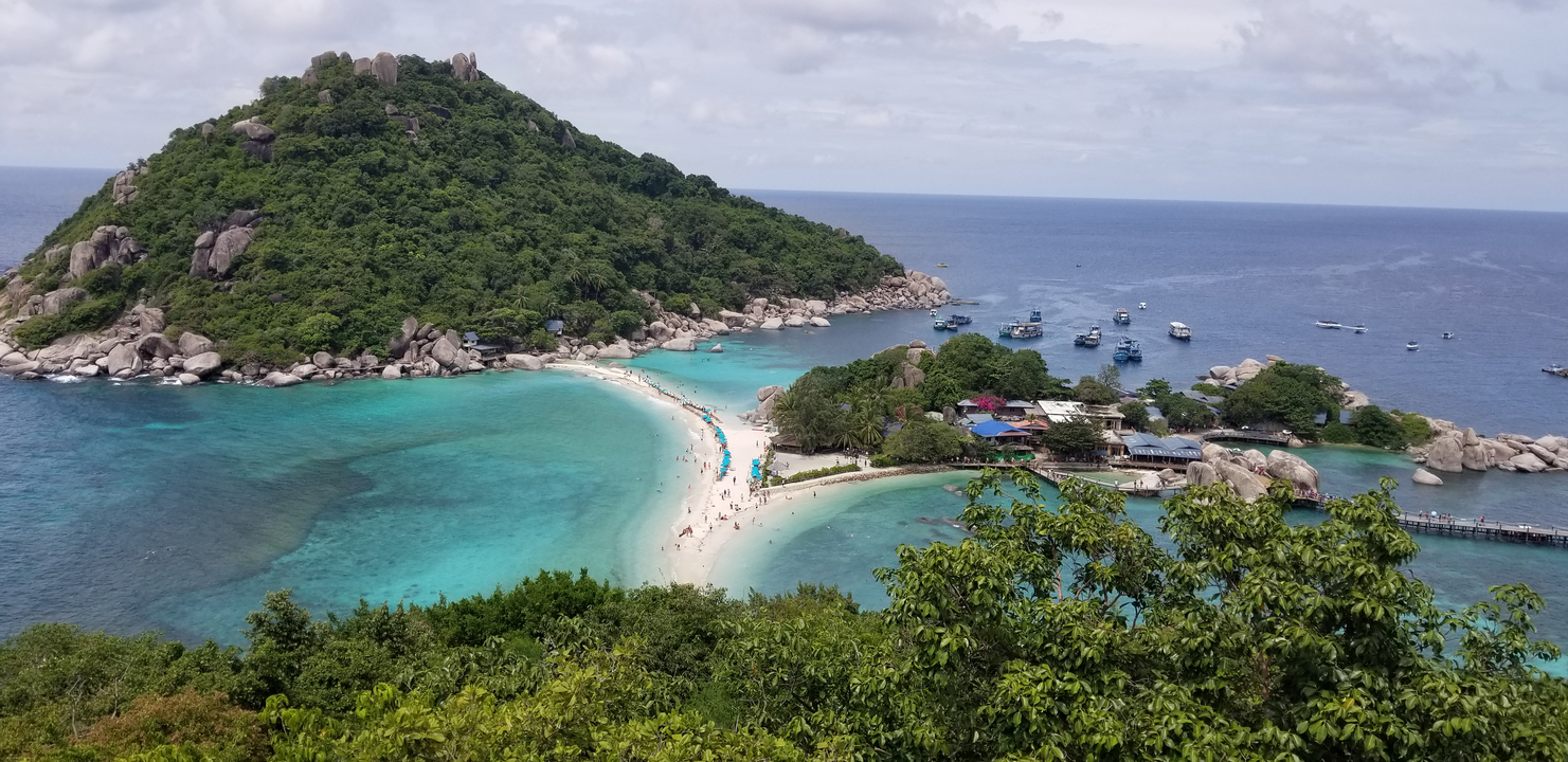 Aerial view of a tropical island with clear turquoise waters.