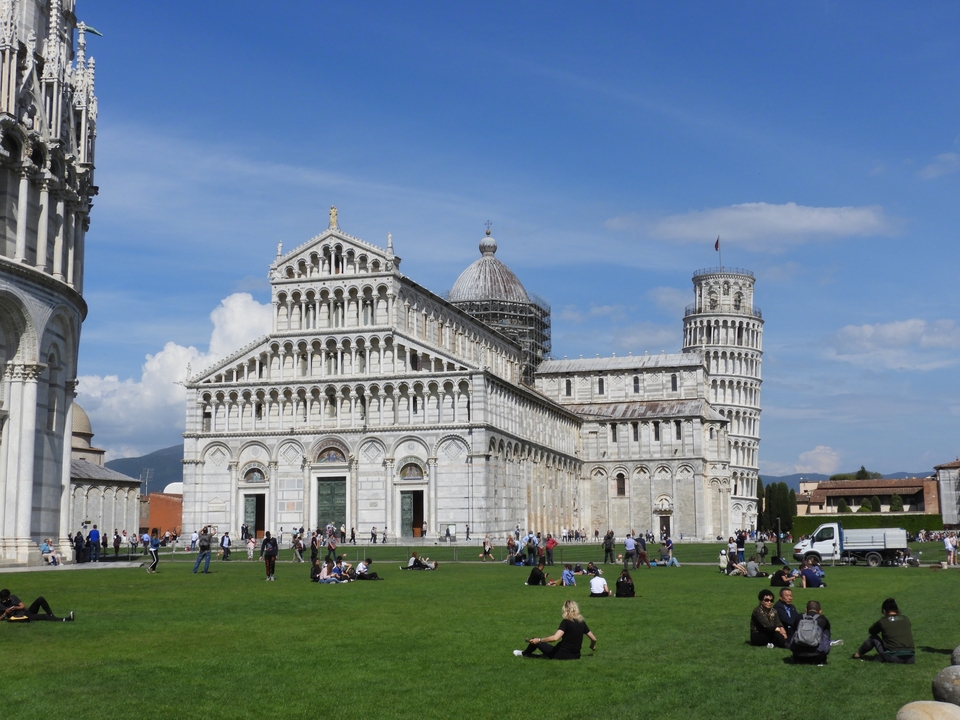 Leaning Tower of Pisa with people on the grass.