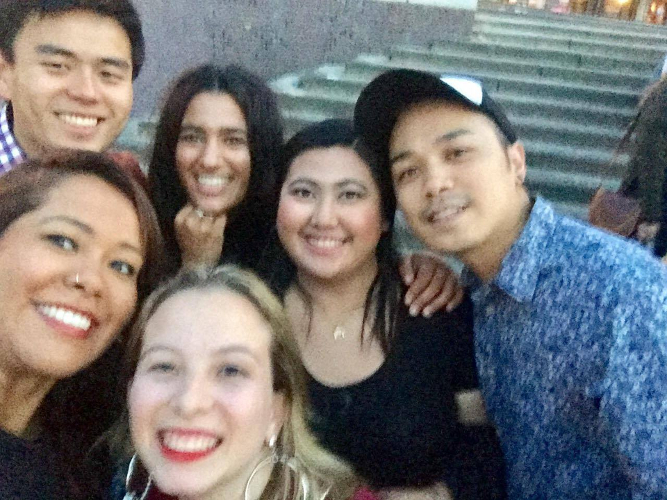 Group selfie at an outdoor location with stairs.