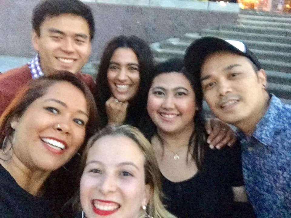 Group selfie at an outdoor location with stairs.