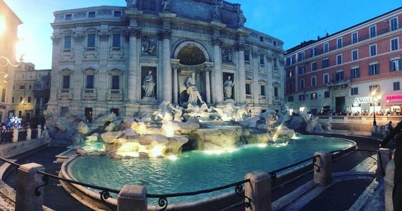 The Trevi Fountain in Rome, beautifully lit in the evening.