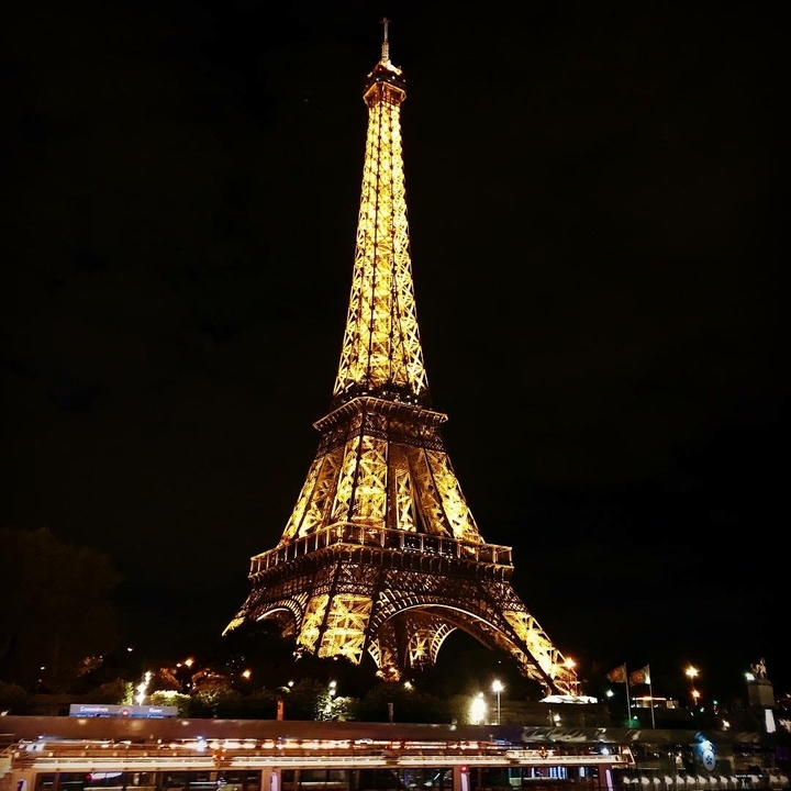Eiffel Tower illuminated at night.