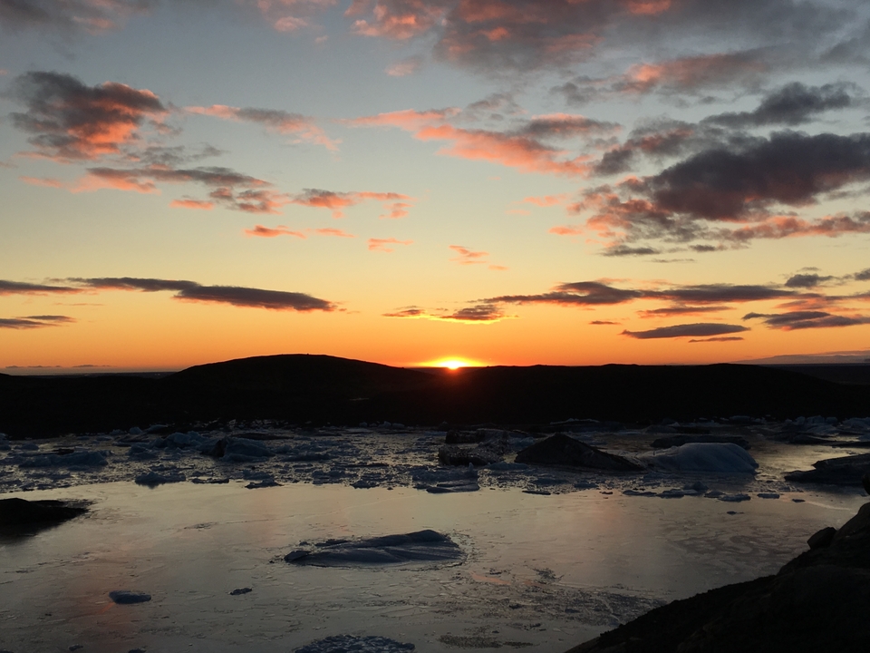 Spectacular sunset over a frozen landscape with icebergs.