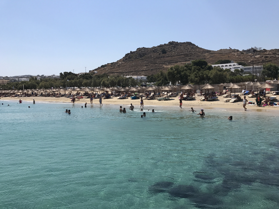Beach with people enjoying the waters and shore.