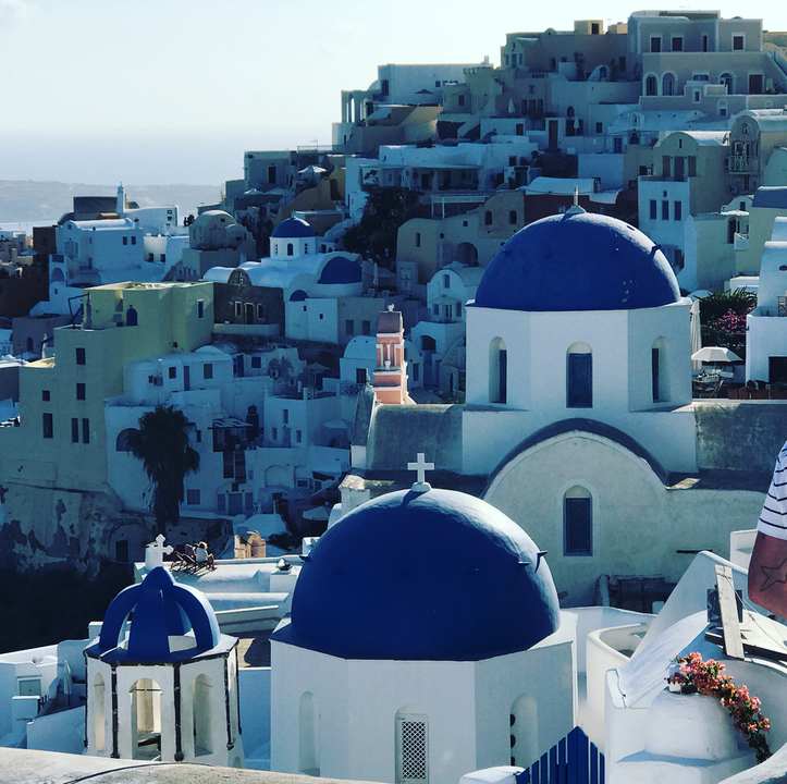 Santorini skyline with blue-domed churches.