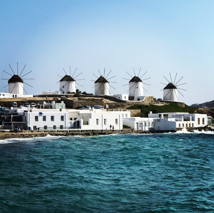 View of iconic windmills by the sea.