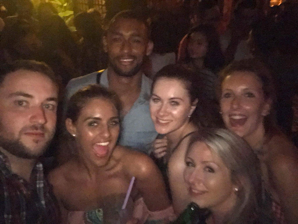 Group of people smiling and posing together at a party.