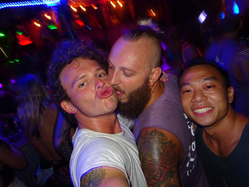 People at a party with neon lights, posing for the camera.