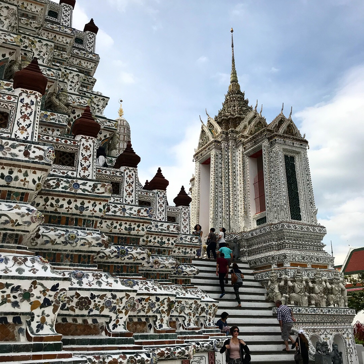 Decoratively tiled temple with visitors exploring.