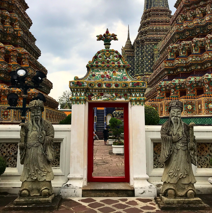 Colorful temple architecture with ornate details and statues.