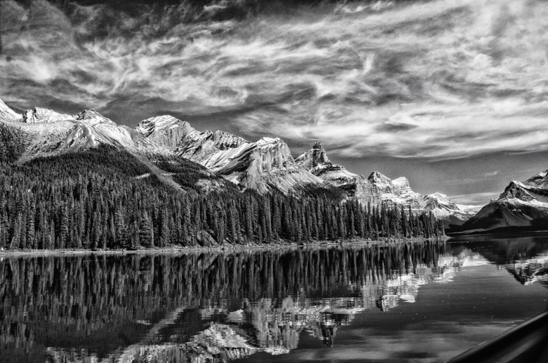 Monochrome view of mountains and a lake.