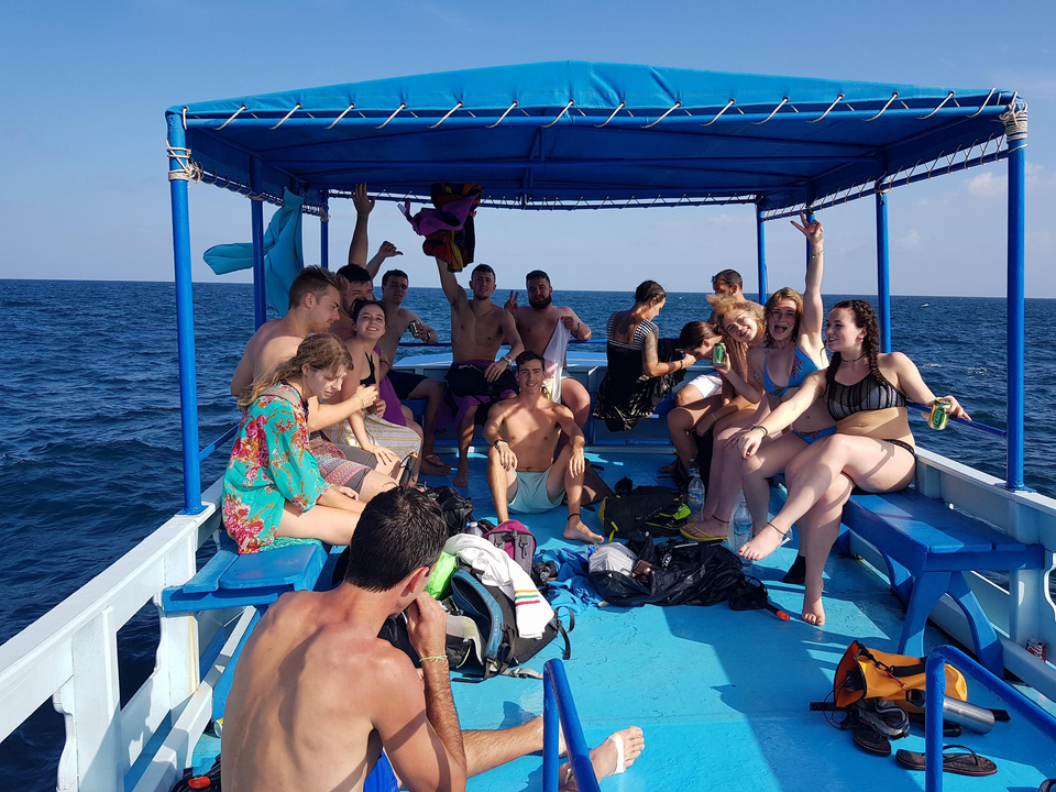 Group of people on a boat enjoying the ocean.