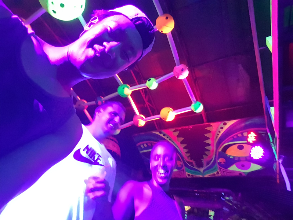 People enjoying neon lights and nightlife.