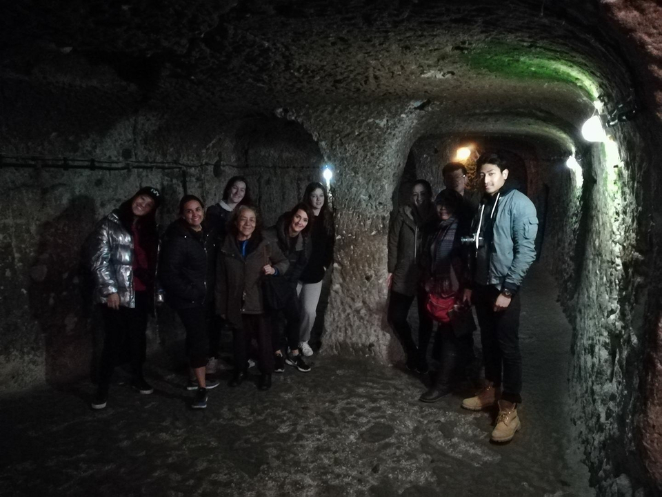 Group of people standing in an underground cave.