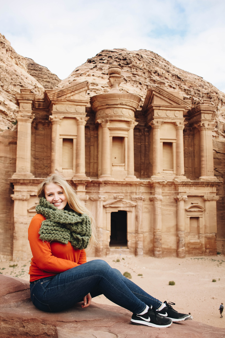 Woman posing in front of a historical monument.