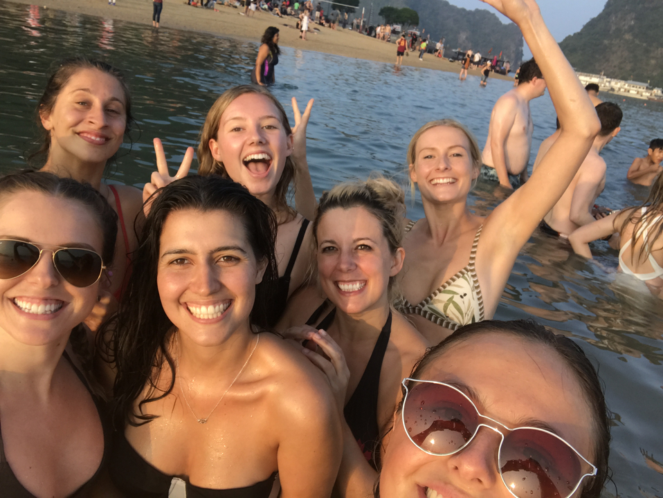Group of people smiling and playing in the water.